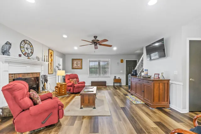 a living room with furniture fireplace and flat screen tv