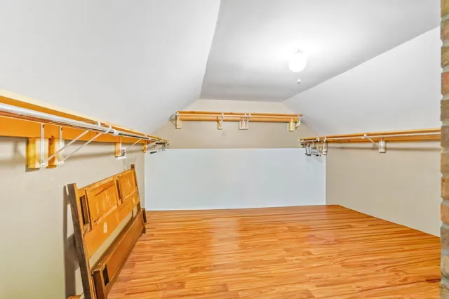 a view of a room with wooden floor and brick walls
