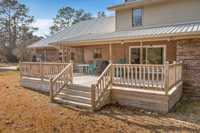 a view of a wooden house with large trees