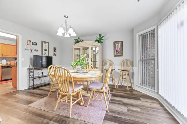 a view of a dining room with furniture and wooden floor