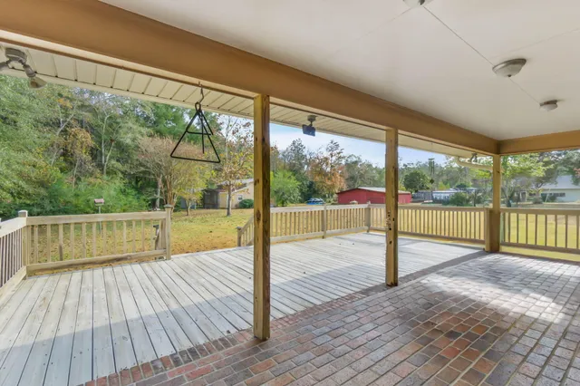 a view of a room with wooden floor and large windows
