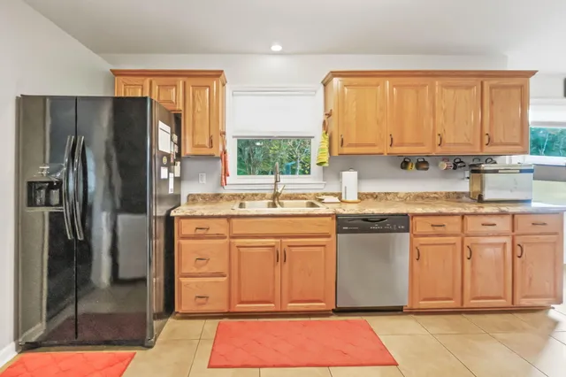 a kitchen with stainless steel appliances granite countertop a refrigerator sink and cabinets