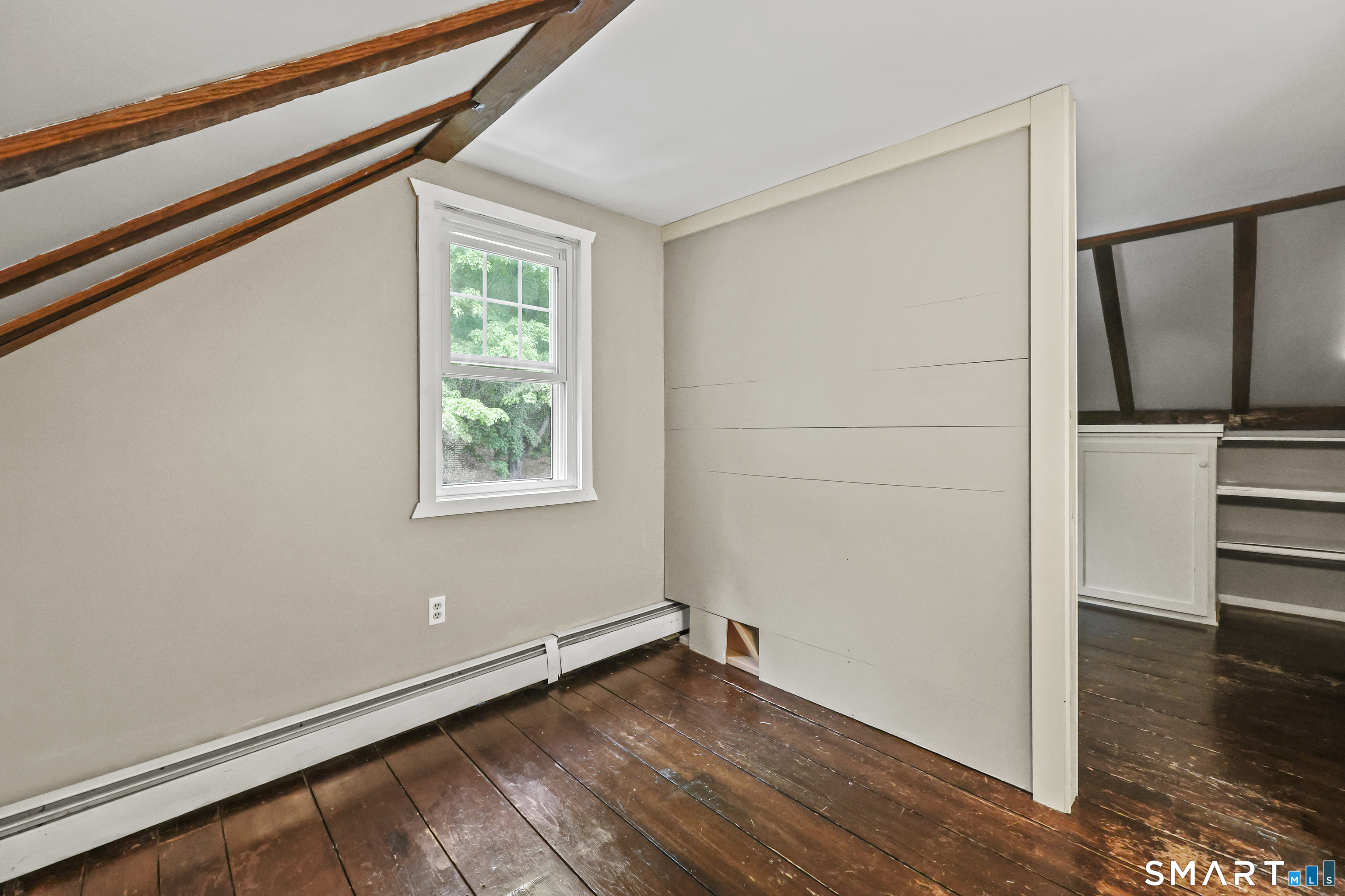 917 Hopewell Road Glastonbury, CT 06033 - Photo 27 of 39 a view of an empty room with wooden floor and a window