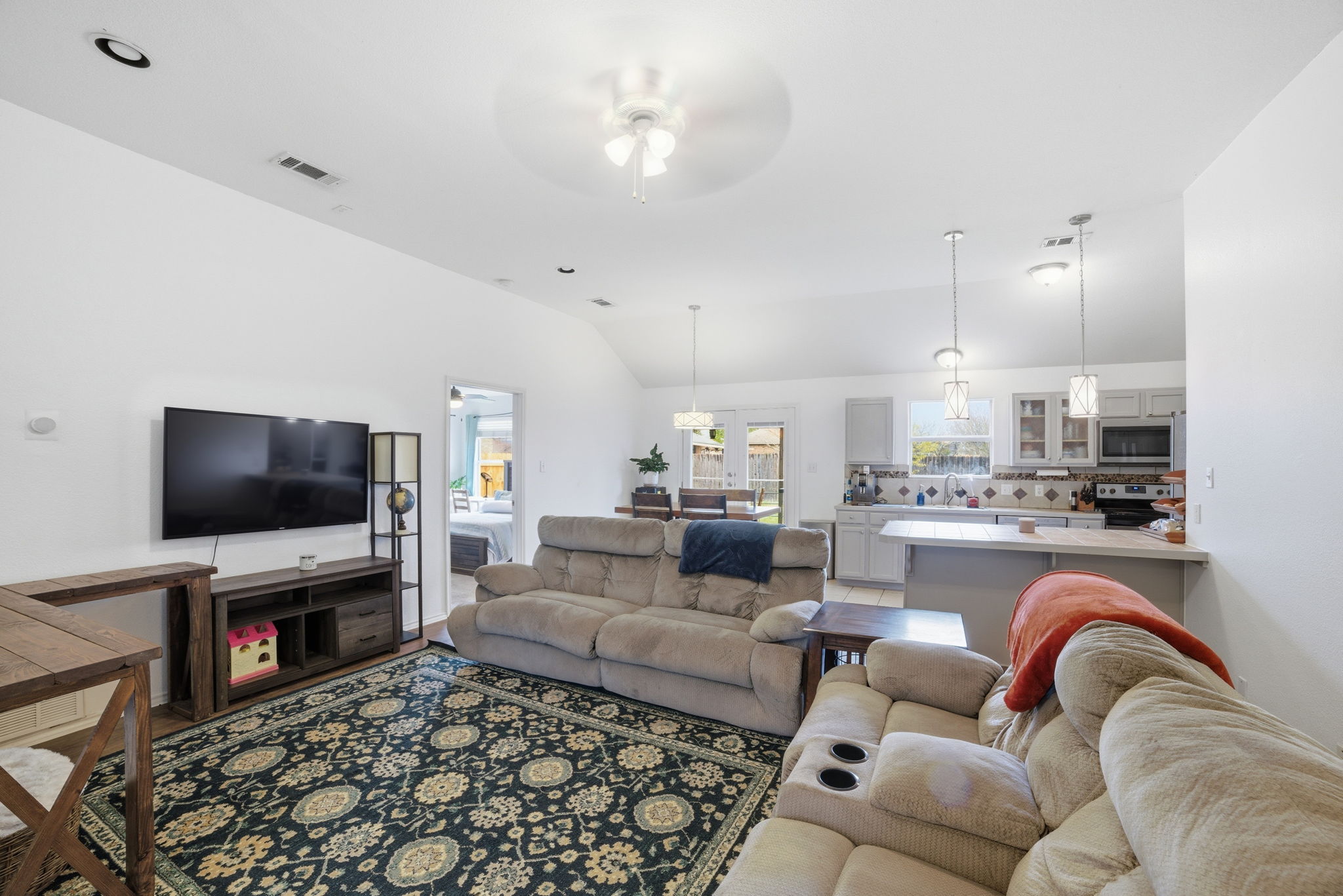 411 Copper Lane Jarrell, TX 76537 - Photo 9 of 32 Ceiling fan and upgraded light fixtures throughout this main area add comfort and charm!