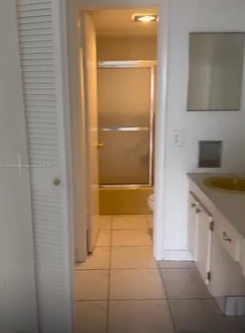 a bathroom with a shower and a sink