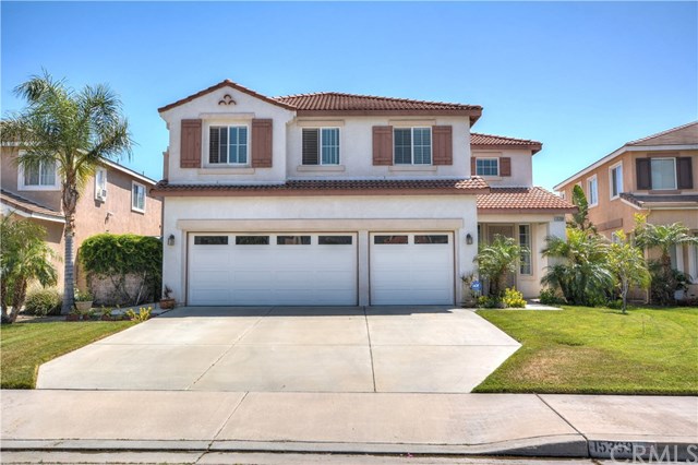 15399 Rochelle Street Fontana, CA 92336 - Photo 1 of 1 a front view of a house with a yard and garage