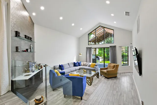 a kitchen with stainless steel appliances white cabinets and a refrigerator