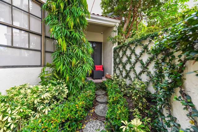 an aerial view of residential houses with outdoor space and swimming pool