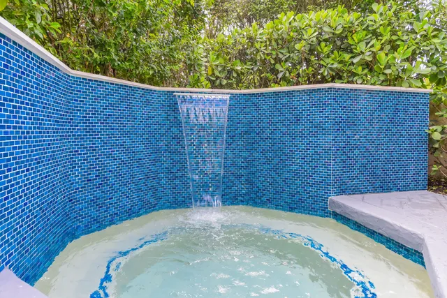 a front view of a house with a potted plant and windows