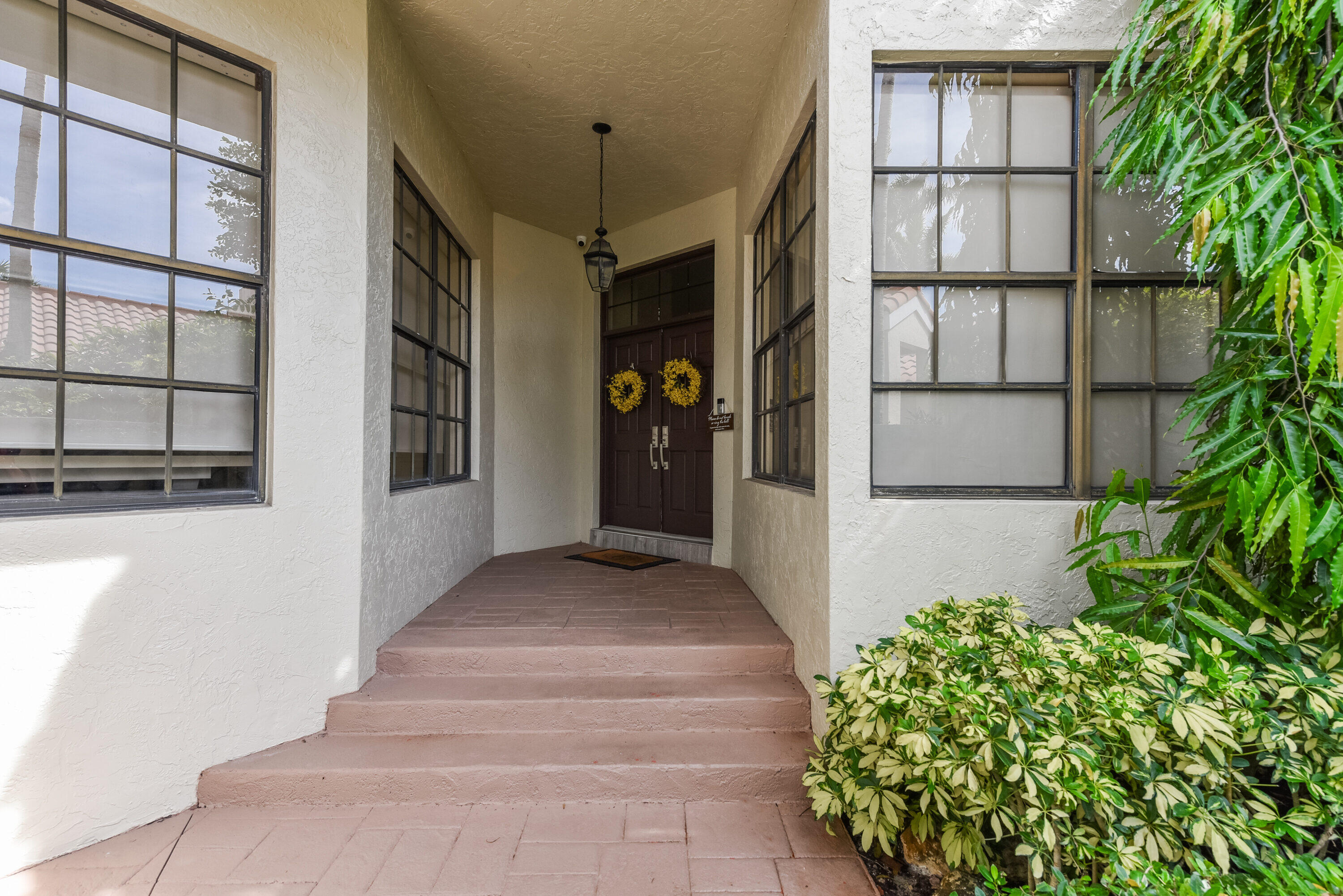 7493 Campo Florido Boca Raton, FL 33433 - Photo 9 of 62 a front view of a house with a potted plant and windows
