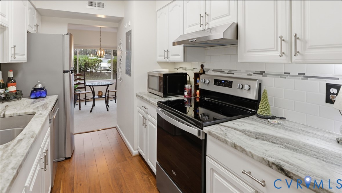 1513 Regency Woods Road, Unit 101 Henrico, VA 23238 - Photo 11 of 50 a kitchen with a stove and a sink