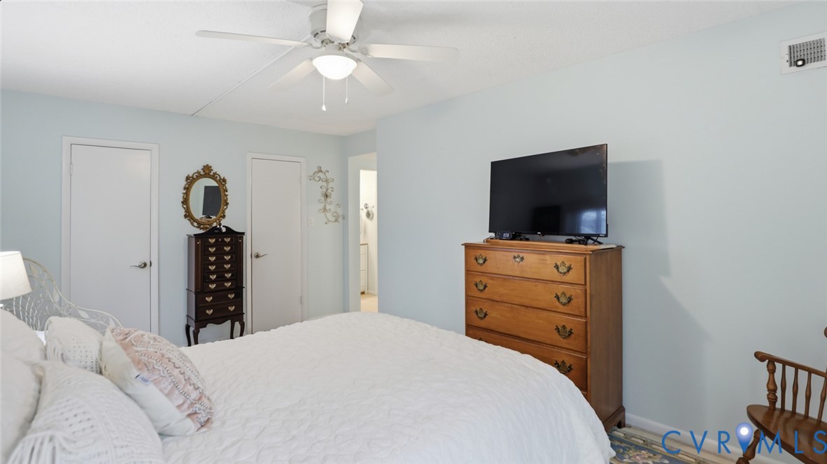 1513 Regency Woods Road, Unit 101 Henrico, VA 23238 - Photo 23 of 50 a bedroom with a bed and a flat tv screen on dresser