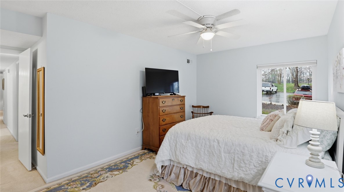 1513 Regency Woods Road, Unit 101 Henrico, VA 23238 - Photo 24 of 50 a bedroom with a bed and a chandelier