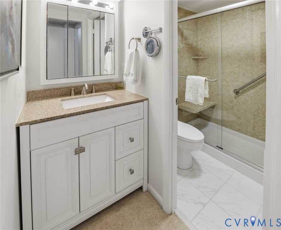 1513 Regency Woods Road, Unit 101 Henrico, VA 23238 - Photo 27 of 50 a bathroom with a granite countertop sink toilet and shower