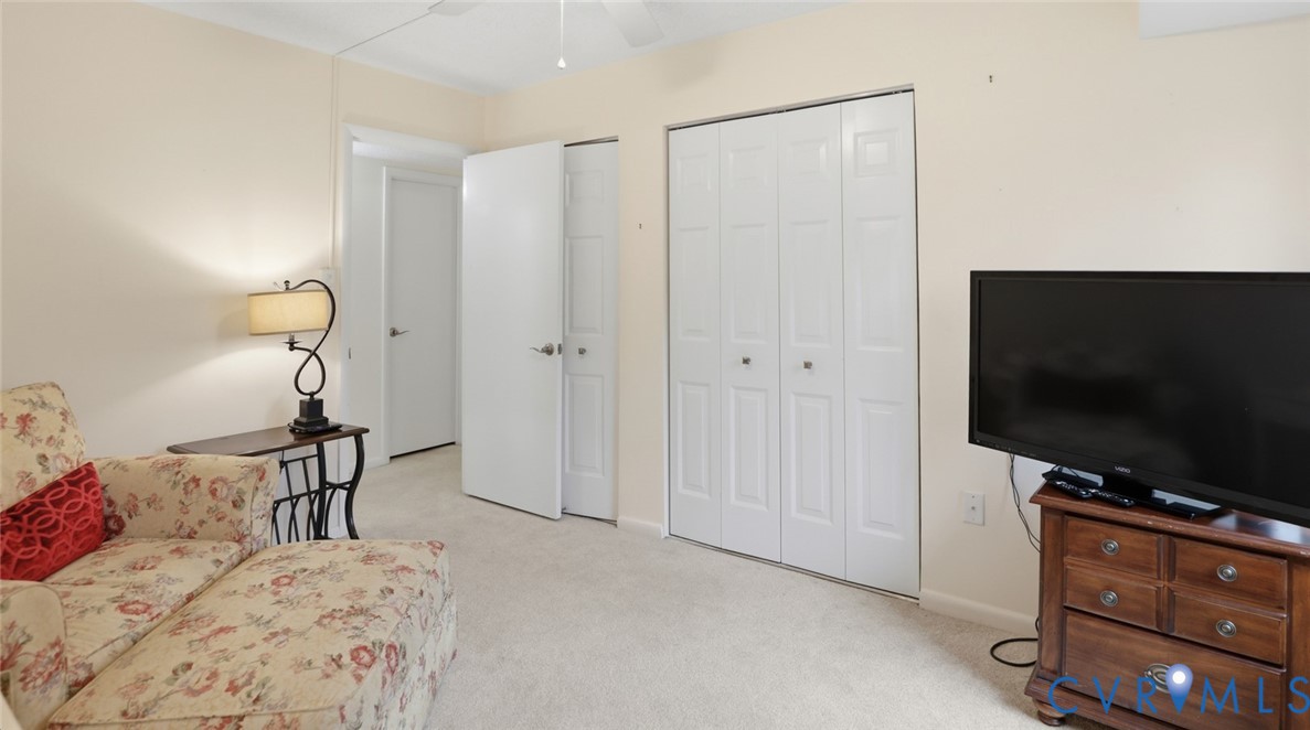 1513 Regency Woods Road, Unit 101 Henrico, VA 23238 - Photo 34 of 50 a bedroom with a bed and a flat screen tv