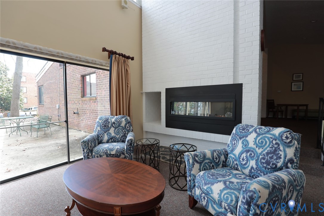 1513 Regency Woods Road, Unit 101 Henrico, VA 23238 - Photo 37 of 50 a living room with furniture a flat screen tv and a large window