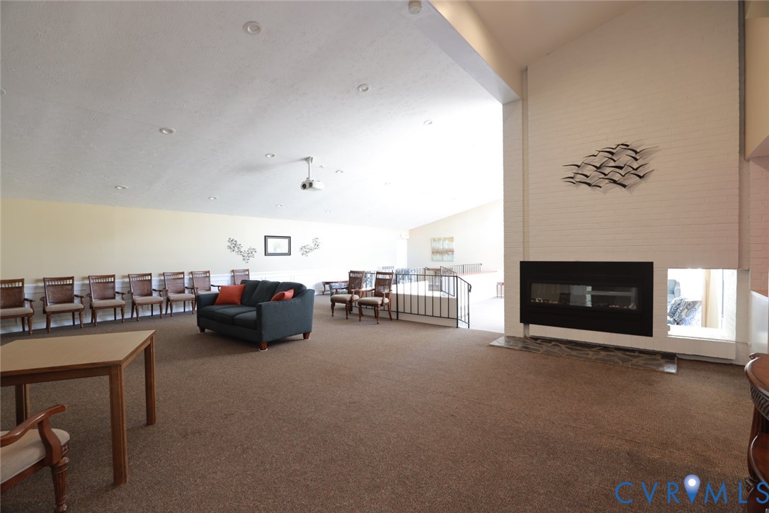 1513 Regency Woods Road, Unit 101 Henrico, VA 23238 - Photo 40 of 50 a living room with furniture and a fireplace