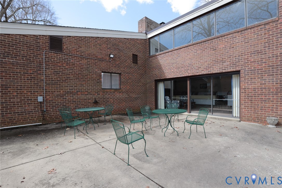 1513 Regency Woods Road, Unit 101 Henrico, VA 23238 - Photo 45 of 50 a patio with a table and chairs and potted plants