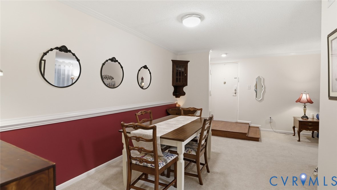 1513 Regency Woods Road, Unit 101 Henrico, VA 23238 - Photo 9 of 50 a view of a dining room with furniture and chandelier