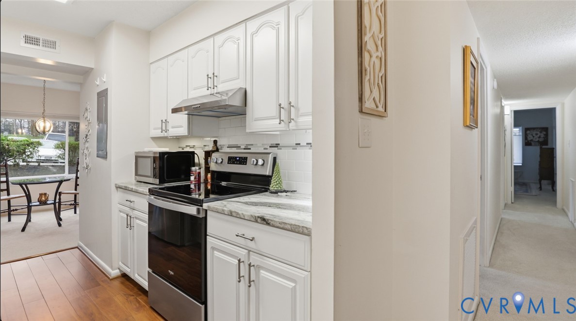 1513 Regency Woods Road, Unit 101 Henrico, VA 23238 - Photo 10 of 50 a kitchen with stainless steel appliances granite countertop a stove a refrigerator and a sink