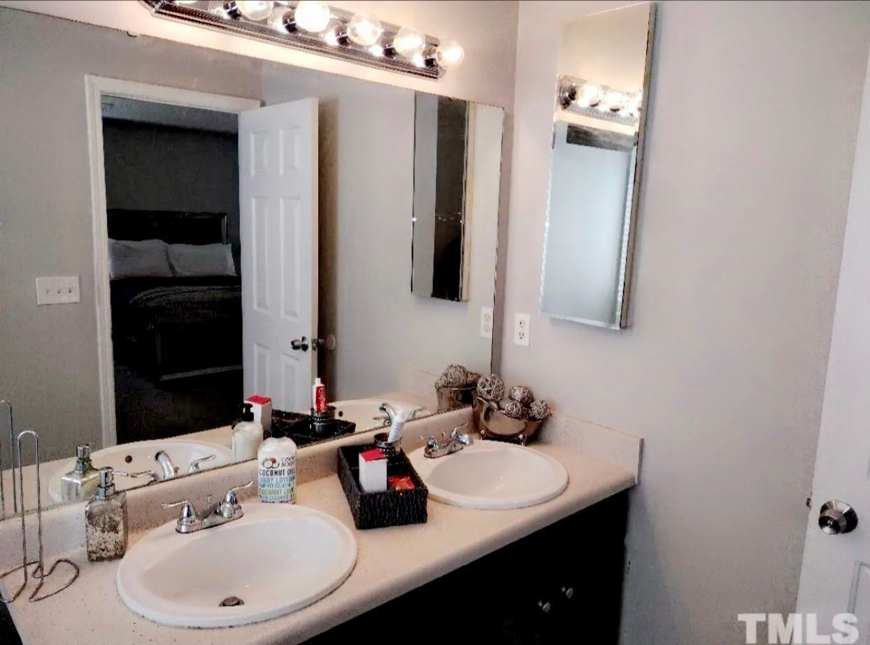 6041 Ricker Road Raleigh, NC 27610 - Photo 13 of 20 a bathroom with a sink and a mirror