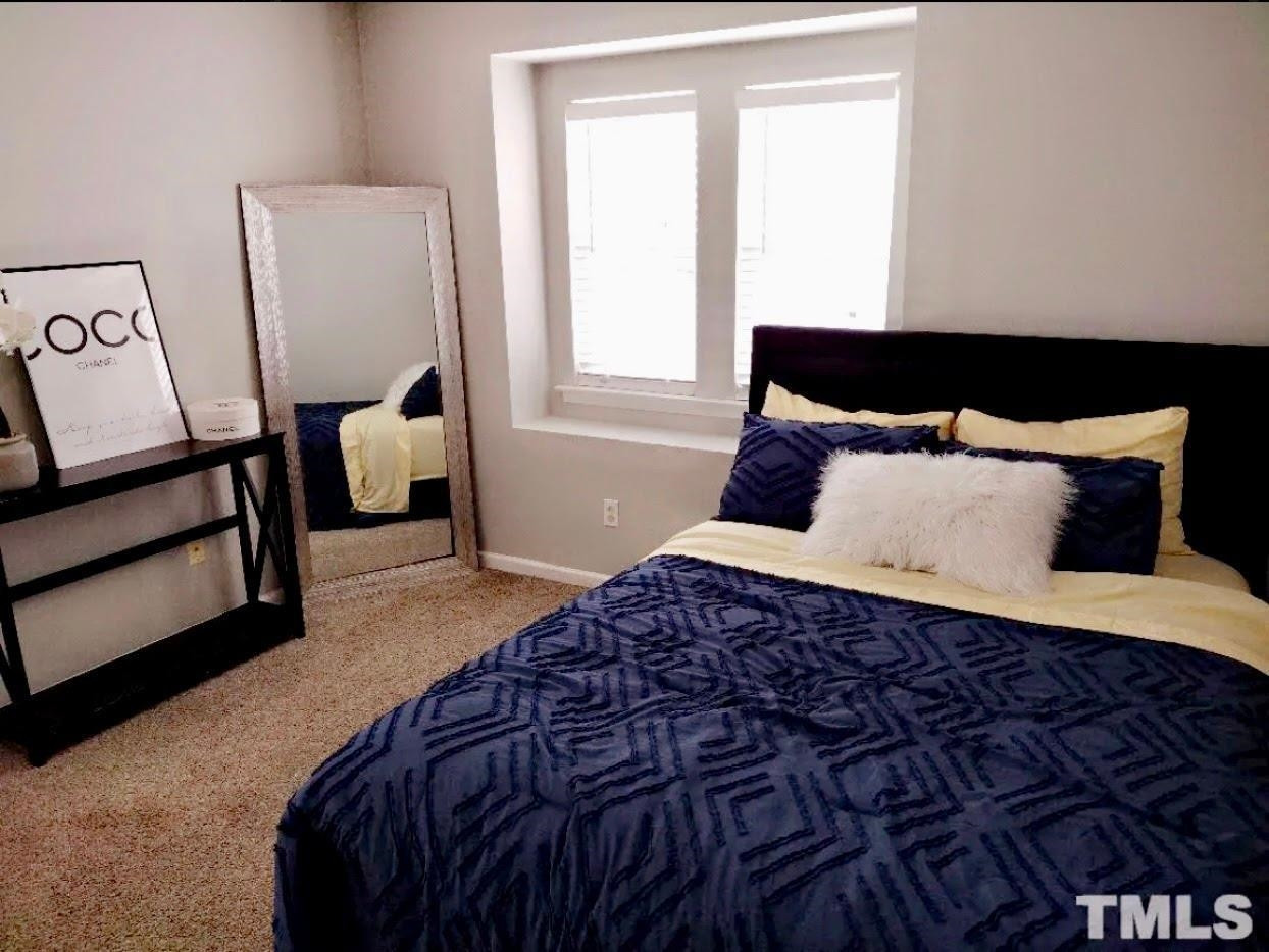 6041 Ricker Road Raleigh, NC 27610 - Photo 16 of 20 a bedroom with a bed and window