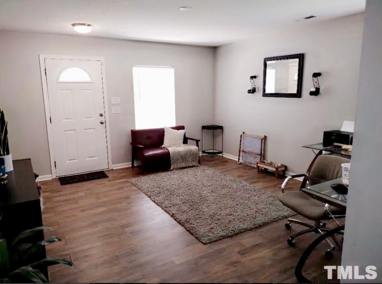 6041 Ricker Road Raleigh, NC 27610 - Photo 4 of 20 a living room with furniture and wooden floor