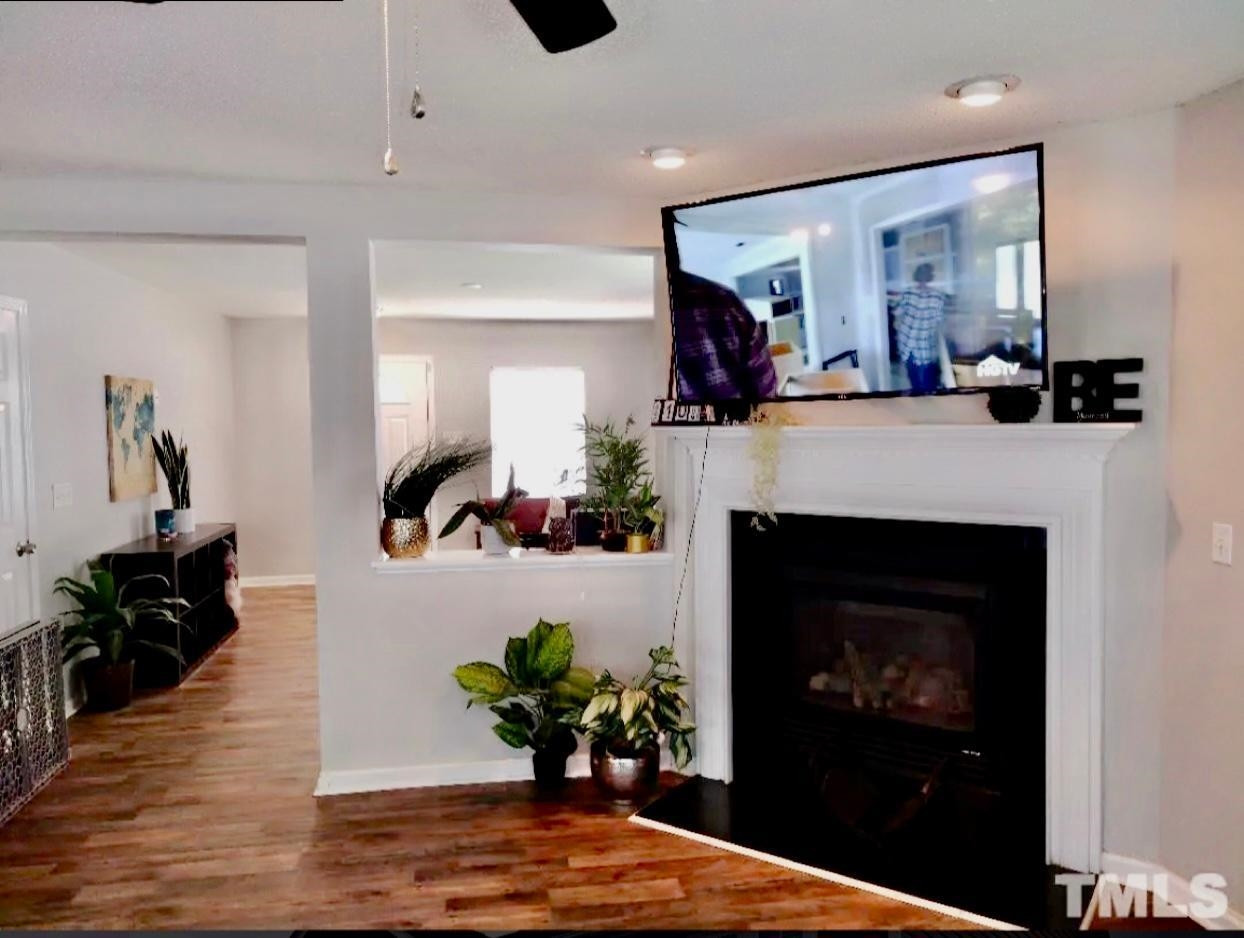 6041 Ricker Road Raleigh, NC 27610 - Photo 6 of 20 a living room with furniture and a fireplace