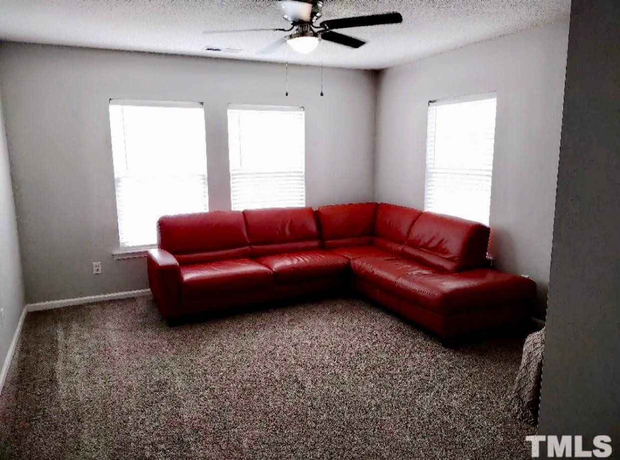 6041 Ricker Road Raleigh, NC 27610 - Photo 9 of 20 a living room with furniture and a window