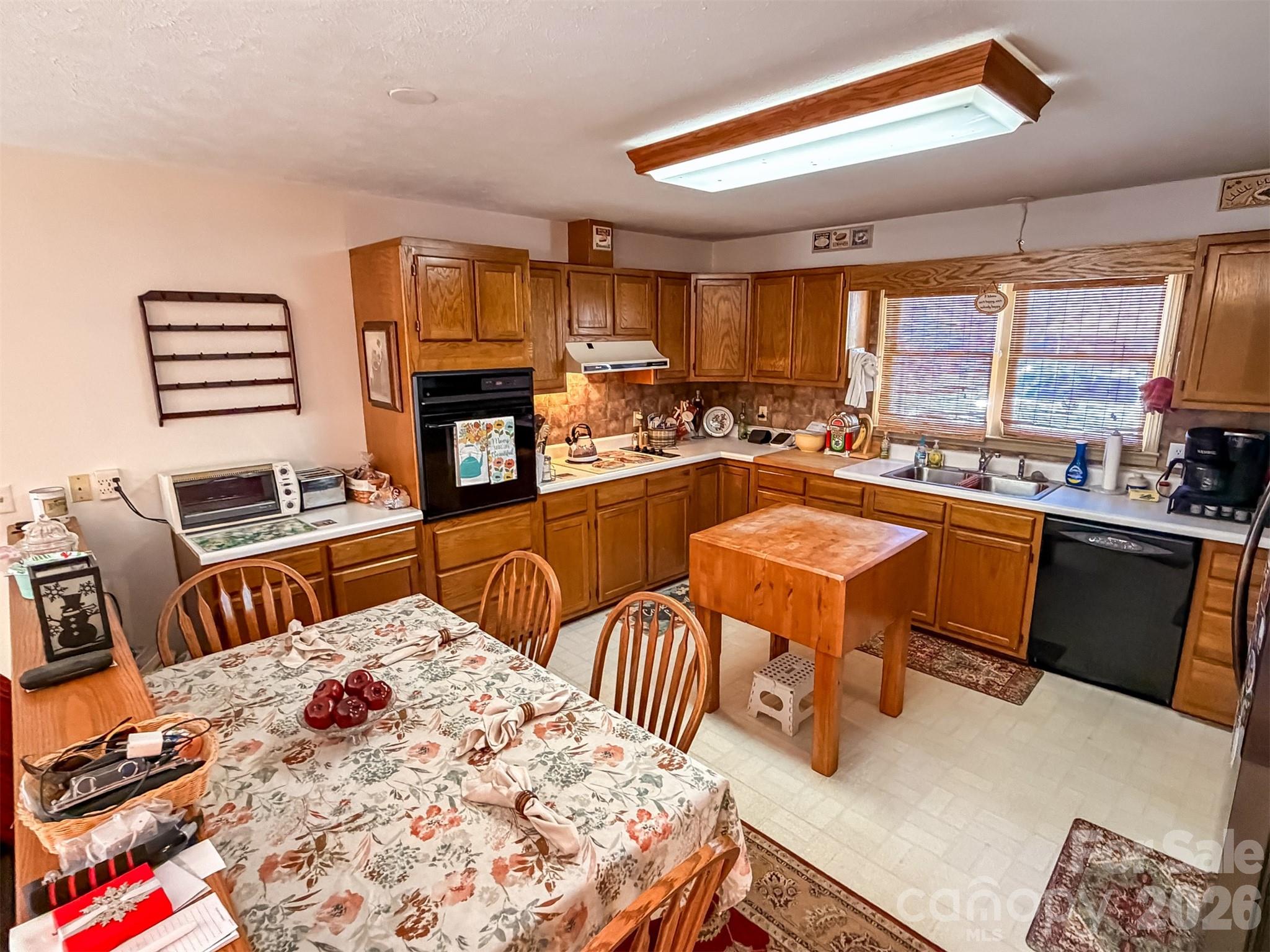 1017 3rd Avenue Northwest Conover, NC 28613 - Photo 12 of 46 a kitchen with stainless steel appliances granite countertop a stove a sink dishwasher and a dining table with garden view