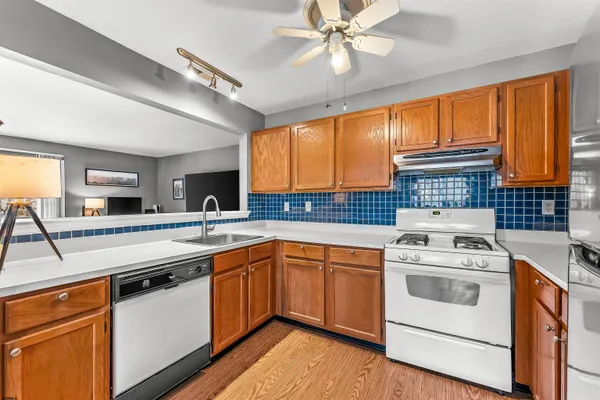 a kitchen with a stove a sink and a microwave
