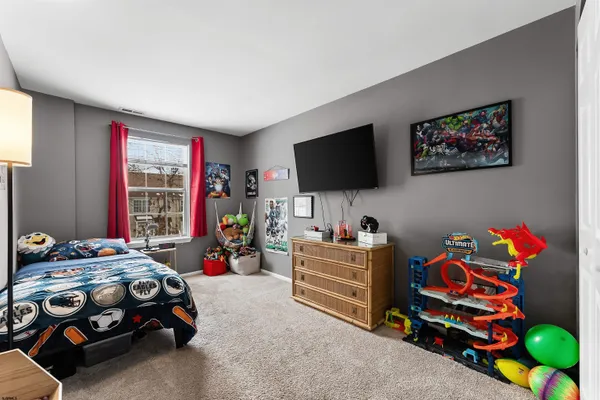 a bedroom with furniture and a flat screen tv