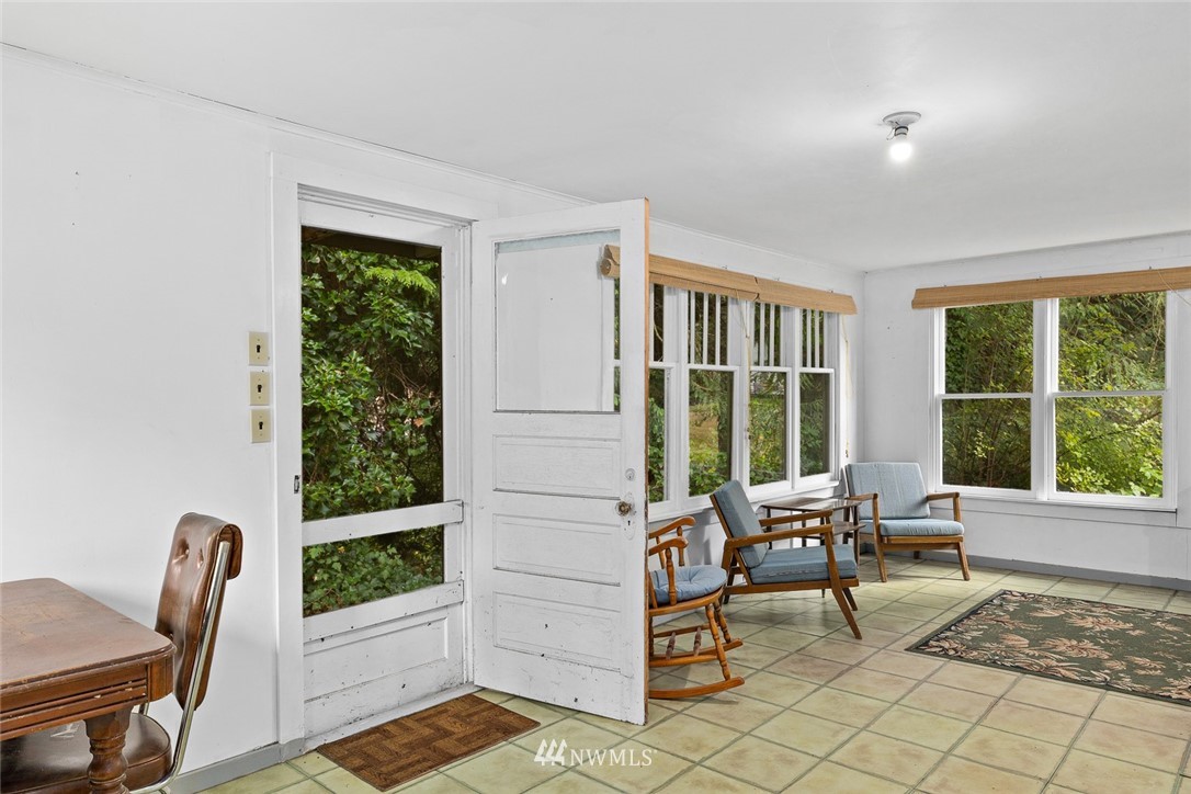 6960 Maxwelton Road Clinton, WA 98236 - Photo 13 of 40 a living room with furniture and floor to ceiling windows