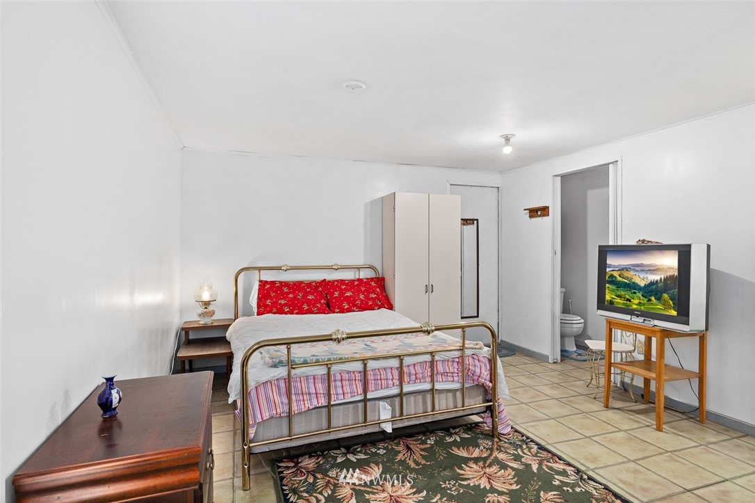 6960 Maxwelton Road Clinton, WA 98236 - Photo 15 of 40 a bedroom with a bed and a flat screen tv