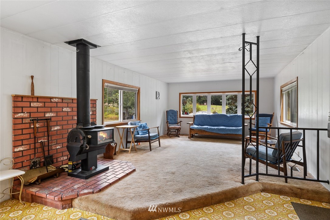 6960 Maxwelton Road Clinton, WA 98236 - Photo 21 of 40 a living room with furniture windows and wooden floor