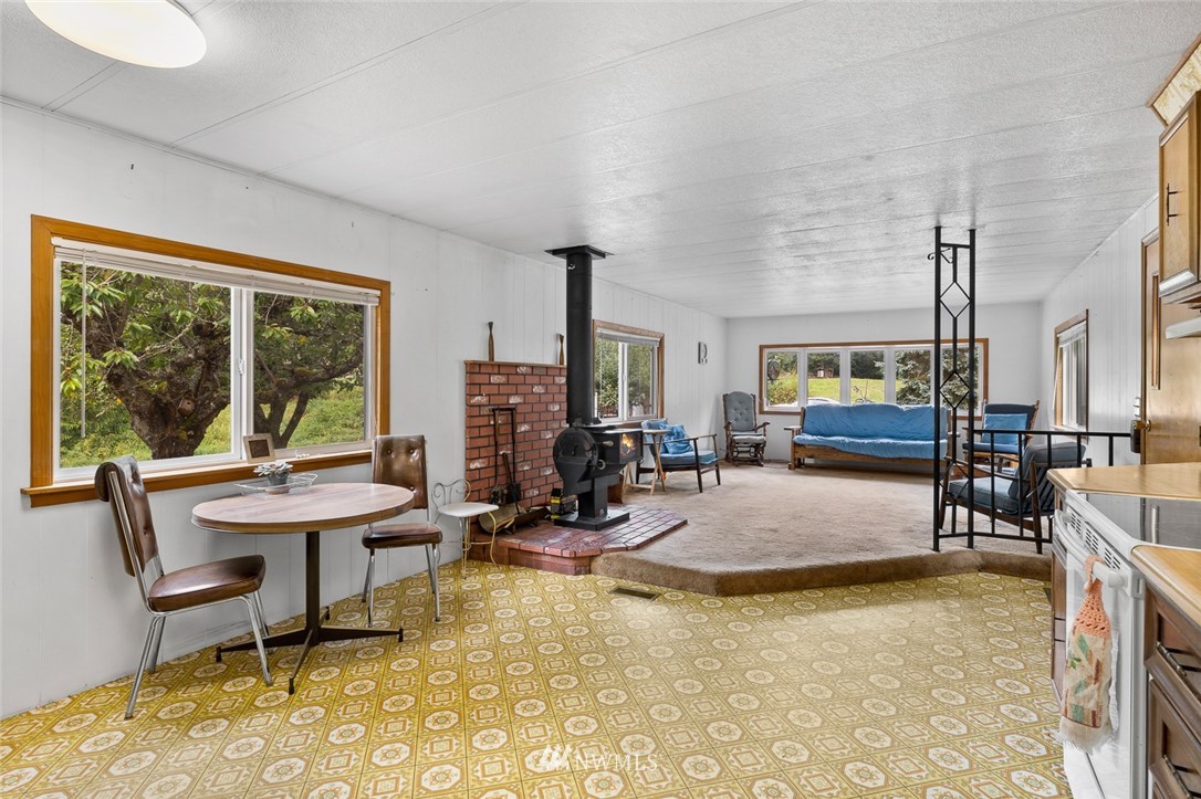 6960 Maxwelton Road Clinton, WA 98236 - Photo 26 of 40 a view of a dining room with furniture and a floor to ceiling window