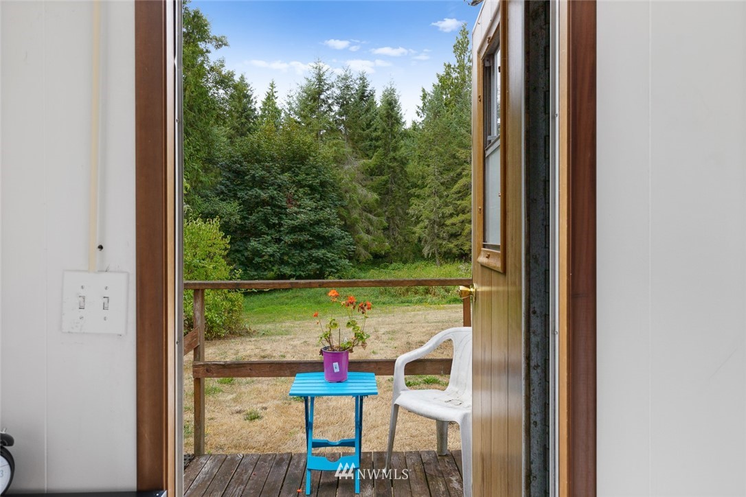 6960 Maxwelton Road Clinton, WA 98236 - Photo 31 of 40 a view of a balcony with chair and table