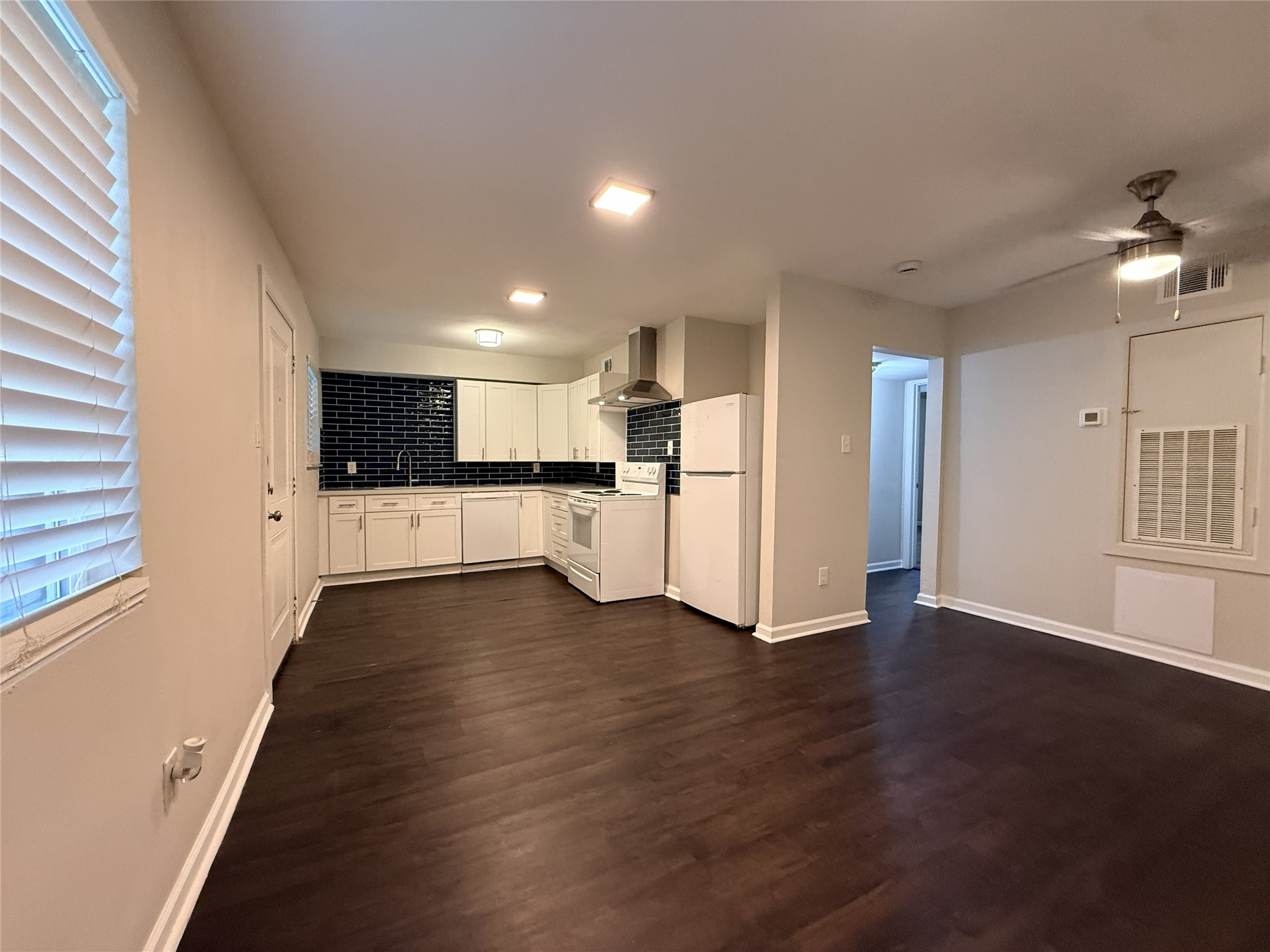 a view of a kitchen with a stove cabinets and wooden floor