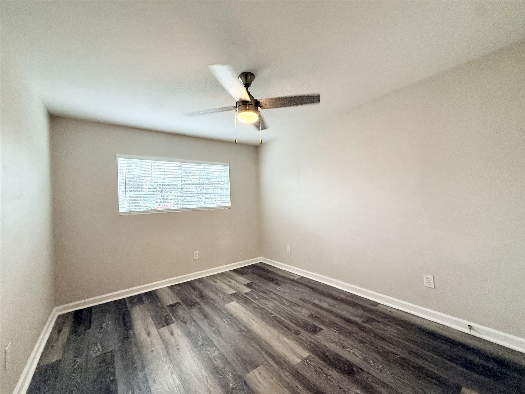 1824 Thonig Road, Unit 4 Houston, TX 77055 - Photo 12 of 13 a view of a room with wooden floor and a ceiling fan