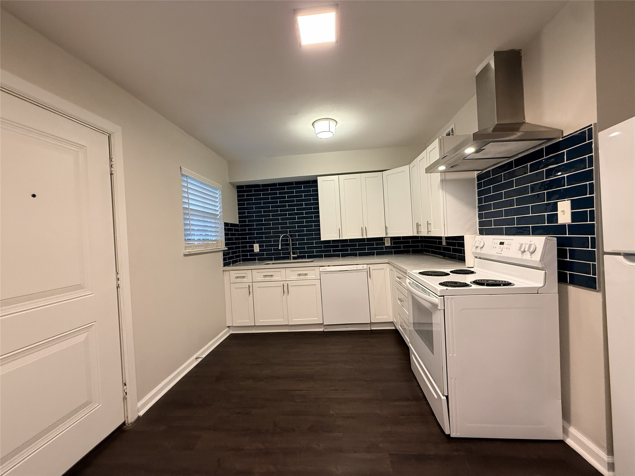 1824 Thonig Road, Unit 4 Houston, TX 77055 - Photo 2 of 13 a kitchen with a stove and white cabinets