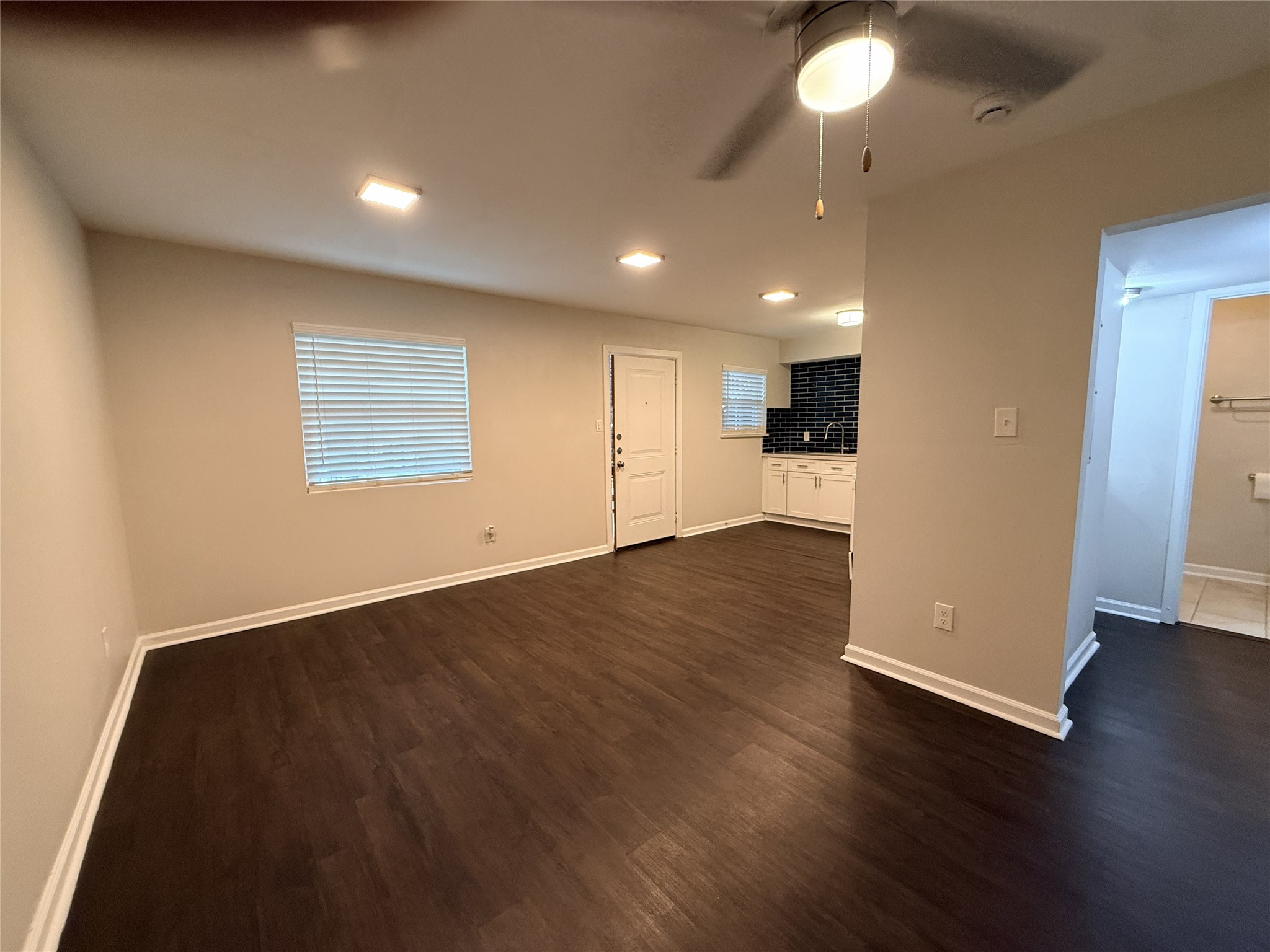 1824 Thonig Road, Unit 4 Houston, TX 77055 - Photo 4 of 13 an empty room with wooden floor and windows