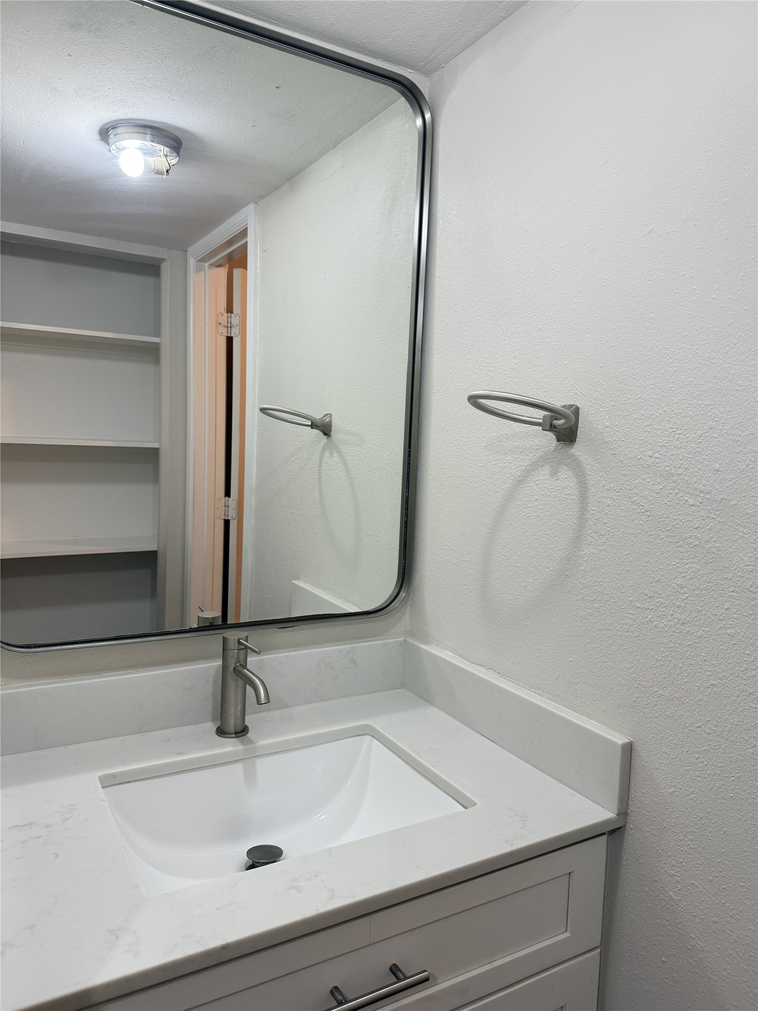 1824 Thonig Road, Unit 4 Houston, TX 77055 - Photo 6 of 13 a bathroom with a sink and mirror
