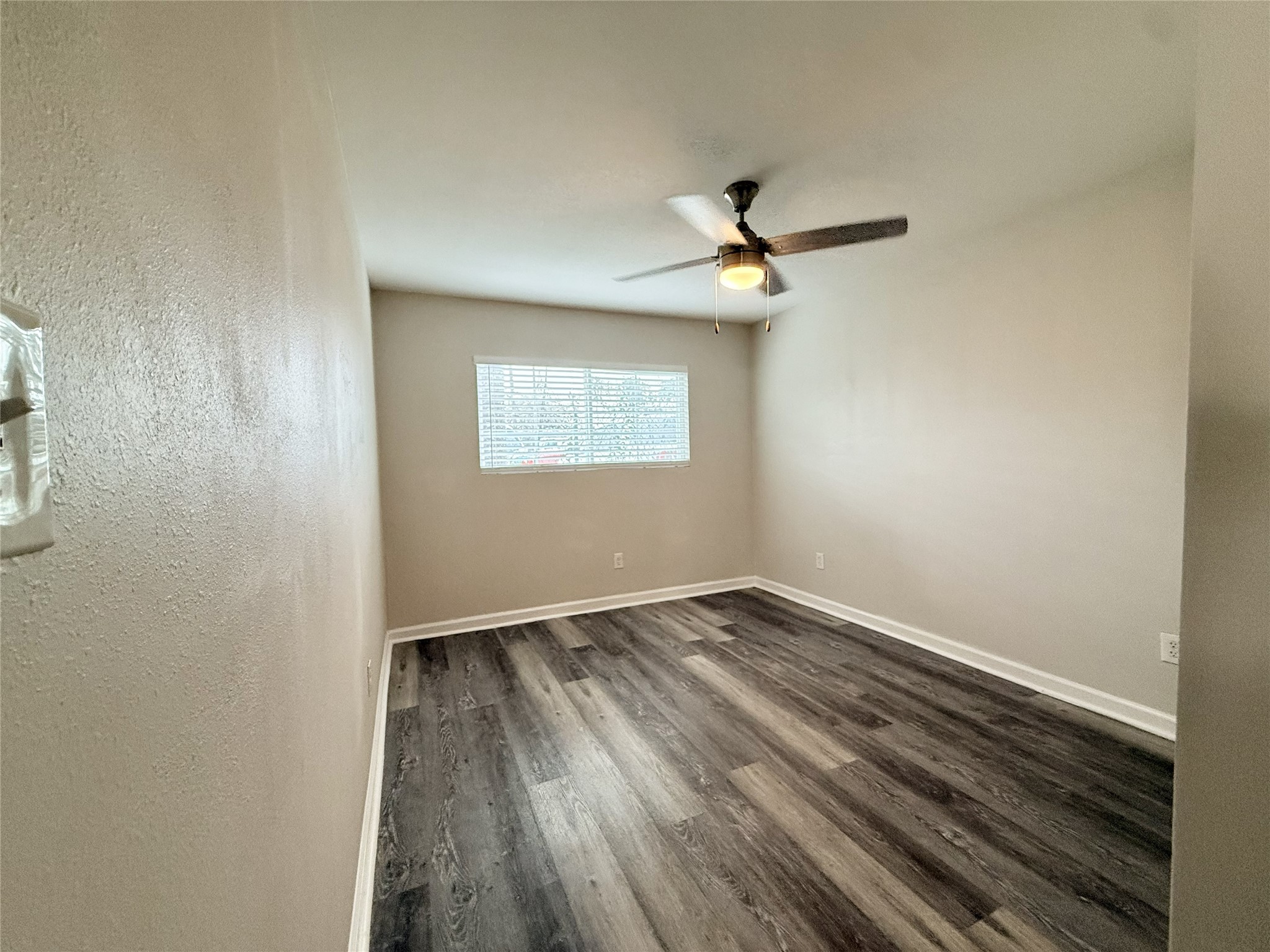 1824 Thonig Road, Unit 4 Houston, TX 77055 - Photo 9 of 13 an empty room with a window and a ceiling fan