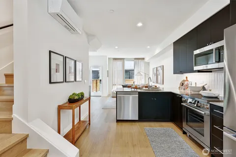 a large kitchen with stainless steel appliances granite countertop a stove and a sink
