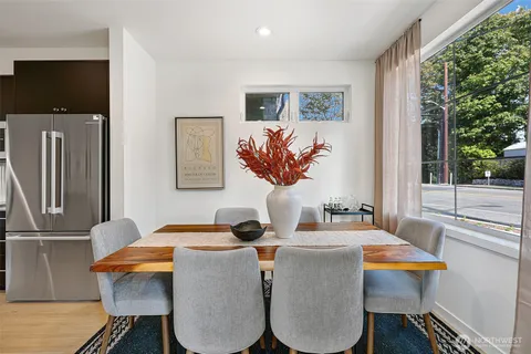 a dining room with furniture and wooden floor