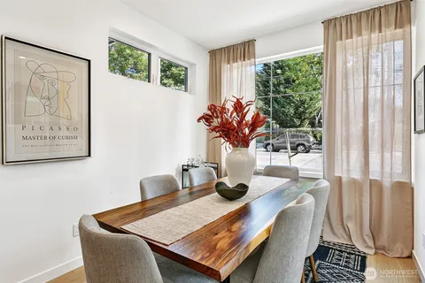 a dining room with furniture and window