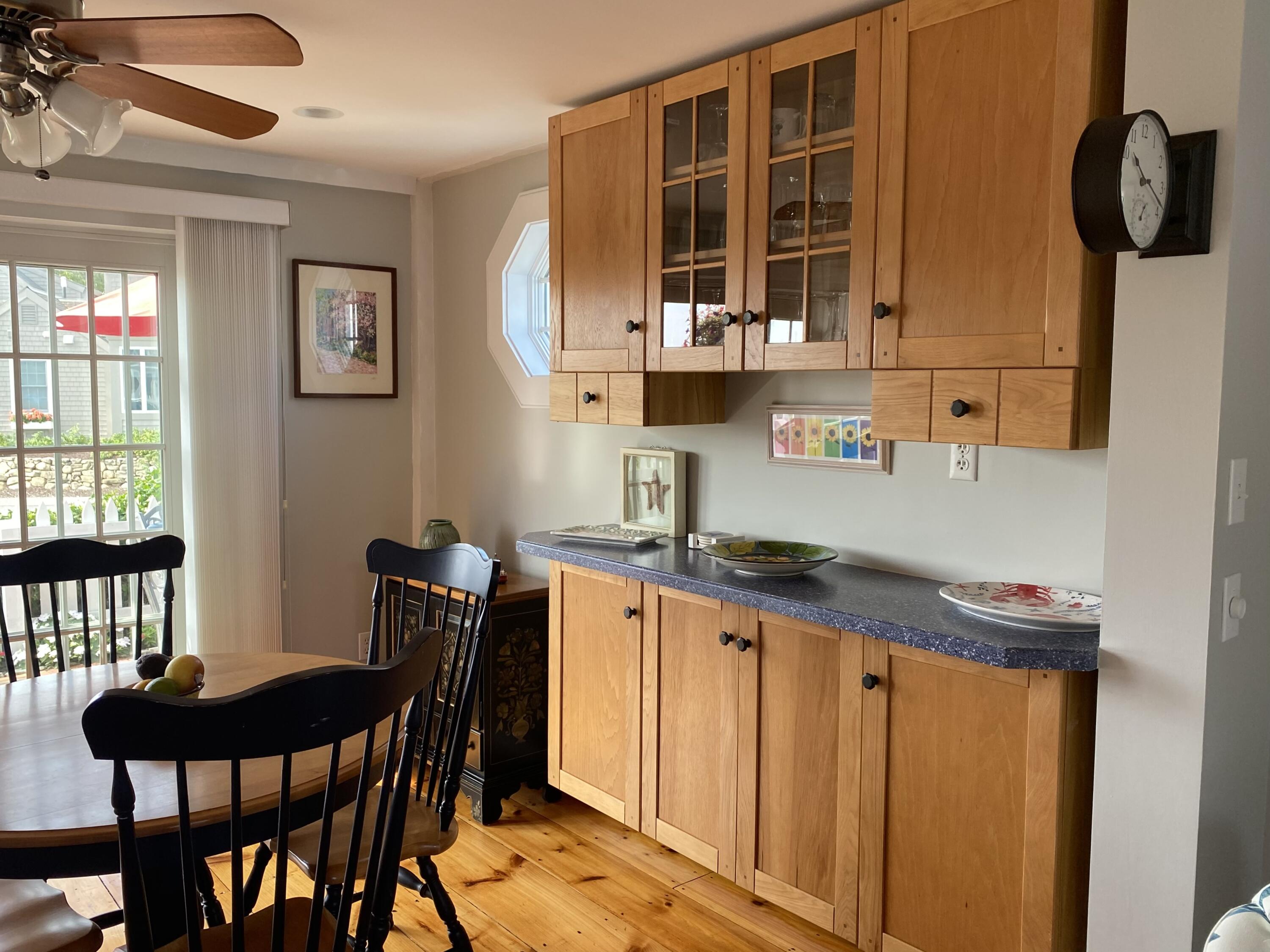 4 Race Point Road Mashpee, MA 02649 - Photo 11 of 37 a kitchen with granite countertop a table chairs stove and cabinets