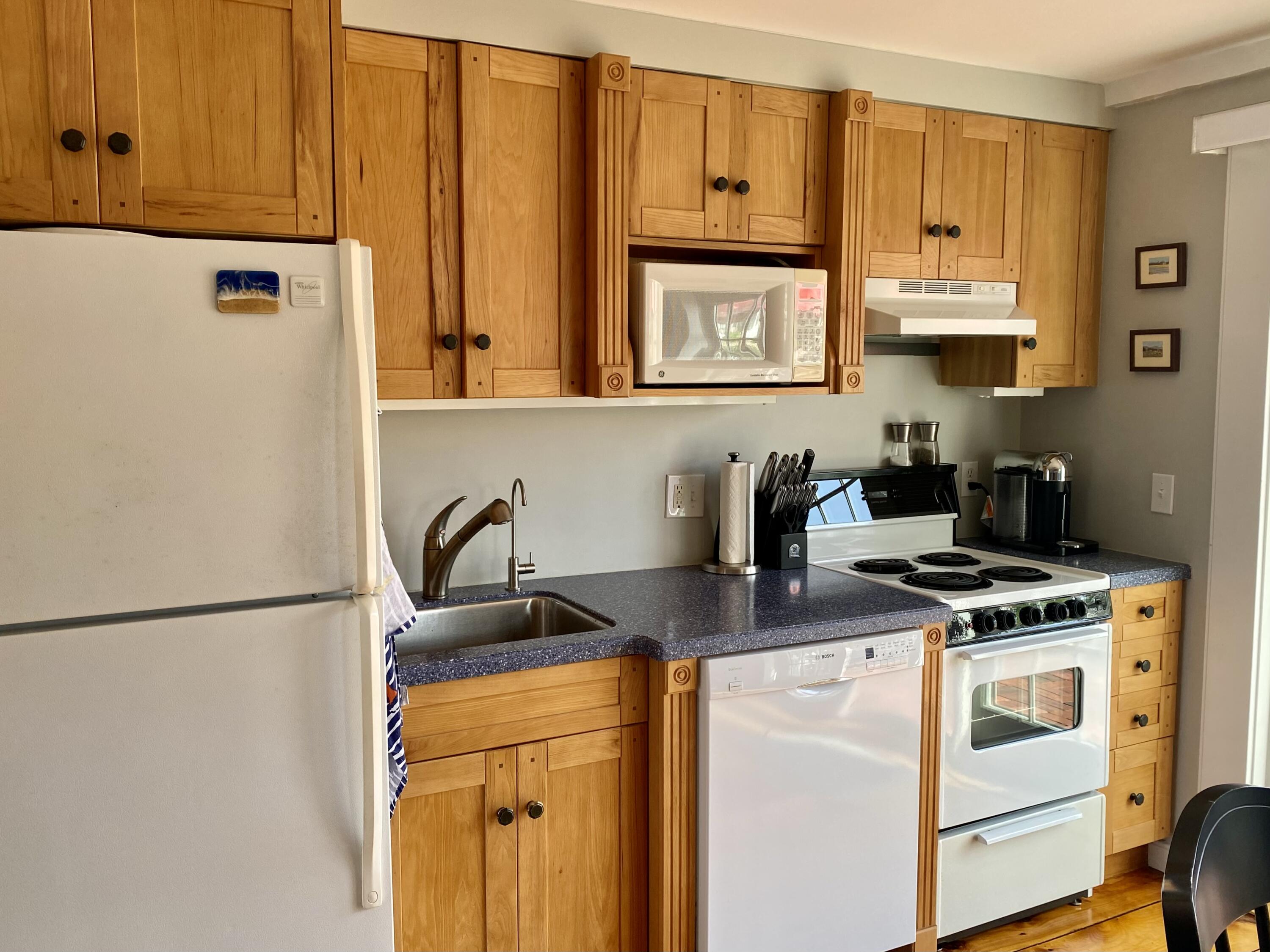 4 Race Point Road Mashpee, MA 02649 - Photo 20 of 37 a kitchen with stainless steel appliances granite countertop a stove a sink and a refrigerator