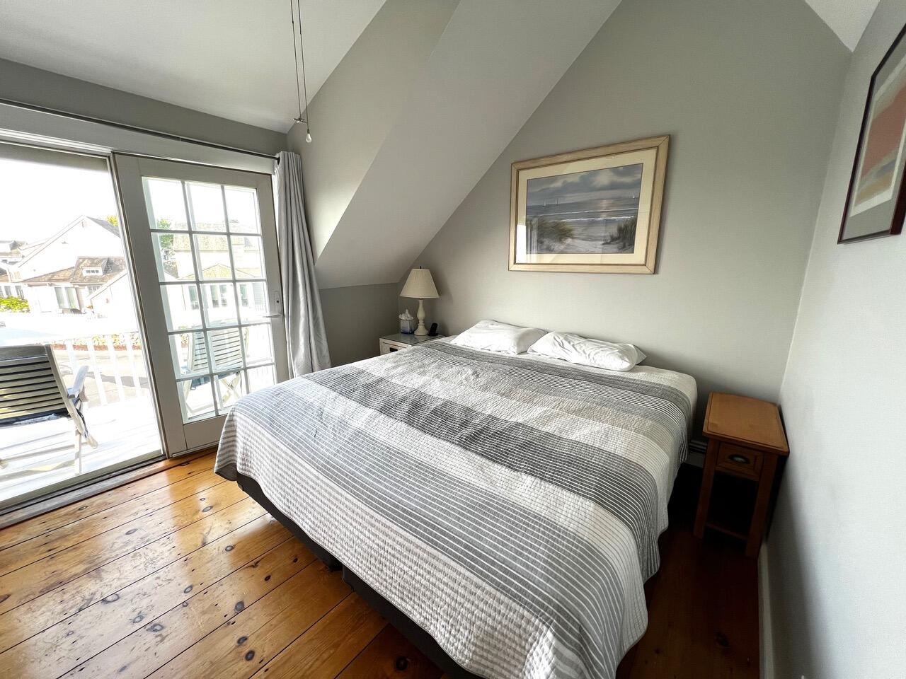4 Race Point Road Mashpee, MA 02649 - Photo 29 of 37 a bedroom with a large bed and a large window