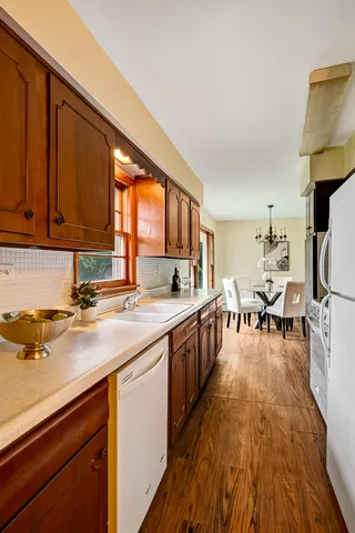 a view of kitchen with wooden floor and electronic appliances